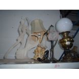 A TIFFANY STYLE LAMP, another lamp, an oil lamp and a Deco style figure group (4)