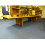 A LARGE BOARDROOM TABLE, made from Bubinga wood, set on three pedestal supports (splits into three