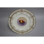 A ROYAL WORCESTER CABINET PLATE, painted with fruit within a gilded pale yellow ground, signed