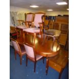 A MODERN MAHOGANY EXTENDING DINING TABLE, and six chairs including two carvers (7)