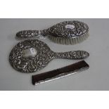 A SILVER DRESSING TABLE SET, to include brush, mirror and comb, hallmarks for Birmingham
