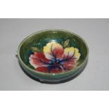 A MOORCROFT POTTERY FOOTED TRINKET DISH, 'Hibiscus' pattern, paper label to base, diameter