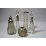 TWO CUT GLASS SCENT BOTTLES WITH STOPPERS, and silver collars on square bases approximately 17.5cm