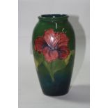 A MOORCROFT POTTERY VASE, Hibiscus pattern, impressed backstamp and blue signature, height