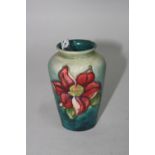 A SMALL MOORCROFT POTTERY VASE, 'Clematis' pattern, impressed backstamps, height approximately