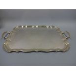 A SILVER TWIN HANDLED TRAY, of shaped rectangular form, Sheffield 1930, approximate weight 109ozt,