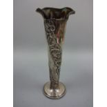 A SILVER TRUMPET VASE, with repousse floral decoration to body, flared rim and weighted circular