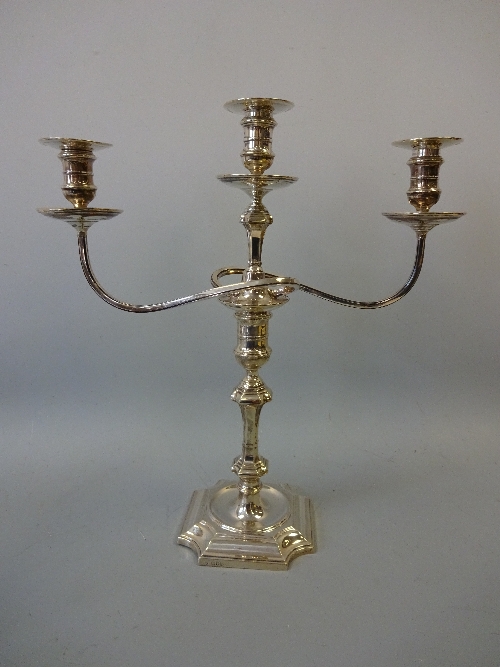 A PAIR OF SILVER THREE BRANCH CANDELABRA, on shaped square bases with central urn supports flanked - Image 2 of 3