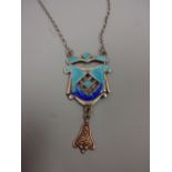 AN ENAMEL PENDANT NECKLACE, with pierced front within a shield shape design and bell shape