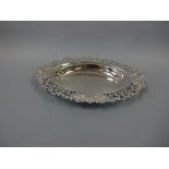 A SHAPED OVAL SILVER DISH, with pierced stylised floral edges and scroll and leaf repousse detail,