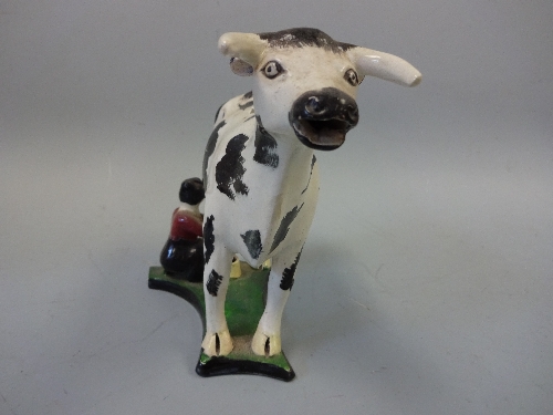 A 19TH CENTURY YORKSHIRE ? PEARLWARE COW CREAMER, decorated in black and white enamels with - Image 2 of 5