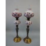 A PAIR OF BOHEMIAN OVERLAID OPAQUE GLASS OIL LAMPS, the matching ruby overlaid glass with opaque