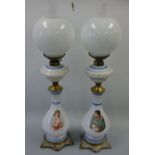 A PAIR OF OPAQUE GLASS OIL LAMPS, decorated with Napoleon and Josephine portraits to baluster