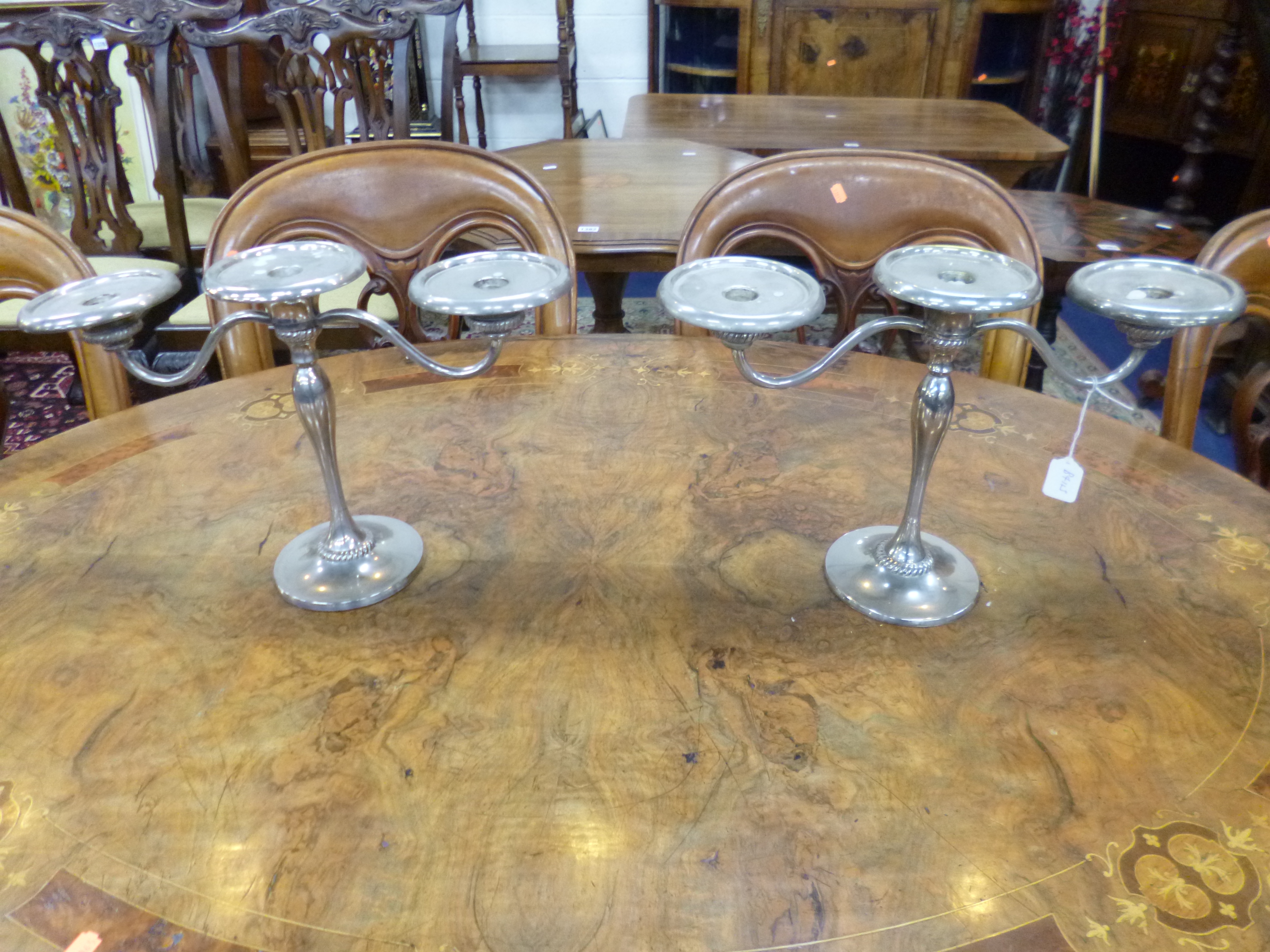 A PAIR OF MODERN PLATED THREE BRANCH TABLE CANDELABRUM