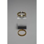 TWO RINGS, the first a 22ct gold band ring, 2.5 grams, together with a single stone brilliant cut