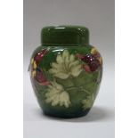 A MOORCROFT POTTERY GINGER JAR, Columbine pattern, impressed and painted marks to base and paper