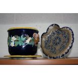 A SMALL MAJOLICA JARDINIERE AND STAND, floral and foliage design, with Rams head handles, height