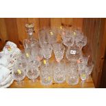 A SUITE OF GLASSWARES, to include decanter, water jug, flutes, brandy etc
