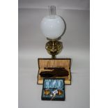 A CASED NOVELTY SALT SET, a cased brush set and an oil lamp (3)