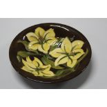 A MOORCROFT POTTERY BOWL, Yellow Lily pattern on brown ground, impressed and painted marks to