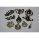 A COLLECTION OF JEWELLERY, to include religious pendants, brooches and a large malachite pendant,