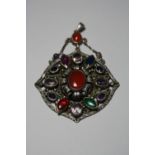 A LARGE MULTI-GEM PENDANT, with central cornelian within a surround of mixed gemstones, suspended