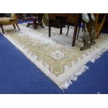 A LARGE INDIAN CREAM AND BEIGE 100% WOOL CARPET, 'Hand knotted in India' label attached, approximate