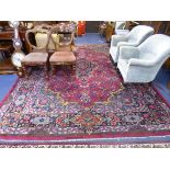 A LARGE RED GROUND FLORALLY DECORATED CARPET, approximate size 368cm x 265cm