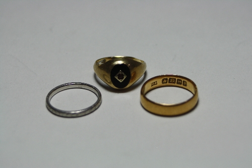 THREE RINGS, to include a platinum band, 2 grams, a 22ct gold band, 3 grams and a signet ring,
