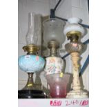 THREE OIL LAMPS, (one converted to electric), together with glass shade