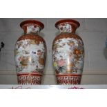 A PAIR OF ORIENTAL BALUSTER VASES, decorated with birds and flowers with gilt highlights over and