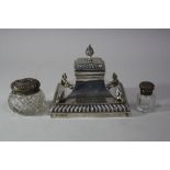 A SILVER CAPSTAN INKWELL, of swept square form with scroll mounts to corners and finial, Sheffield