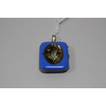 A LOCKET, of rectangular shape, with central floral spray relief with blue/turquoise enamel, no