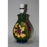 A MOORCROFT POTTERY LAMP BASE, Hibiscus pattern, impressed mark to base, height approximately 21cm