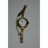 A LADIES WATCH, with circular white dial and Arabic numbers, hallmarks for 18ct gold to the watch
