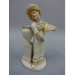 A ROYAL WORCESTER FIGURE, girl standing before urn holding fan, modelled by James Hadley in Kate