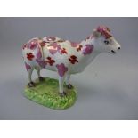 A SWANSEA ? PEARLWARE COW CREAMER, c.1850, of typical form decorated with pink lustre and iron red