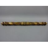 A BRASS SCROLL HOLDER, with applied moulded acorn and oak leaf decoration, twisting end to reveal