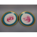 A PAIR OF MINTONS CABINET PLATES, with puce cupid and cherub central decoration within blue border