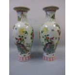 A PAIR OF ORIENTAL BALUSTER VASES, decorated in coloured enamels with birds of paradise, flowers and