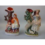 TWO 19TH CENTURY STAFFORDSHIRE SPILL VASES, decorated in coloured enamels, modelled as Red Riding