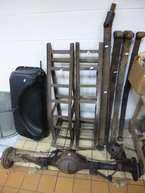 A VINTAGE CAR DIFFERENTIAL REAR AXLE, leaf springs, petrol tank and a pair of car ramps