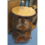 A CIRCULAR WALNUT INLAID REVOLVING BOOKCASE