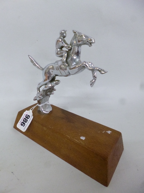 A CHROME CAR MASCOT, of a jumping horse and jockey on a wooden plinth