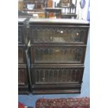 A GLOBE WERNICKE LEAD GLAZED THREE SECTION BOOKCASE, on seperate base (including one spare door)