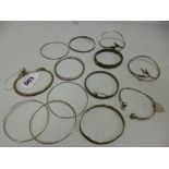 A COLLECTION OF WHITE METAL BANGLES (13)