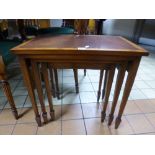 A MAHOGANY AND YEW WOOD NEST OF THREE TABLES