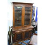 A VICTORIAN WALNUT GLAZED TWO DOOR BOOKCASE, with single drawer and cupboard to base, approximate