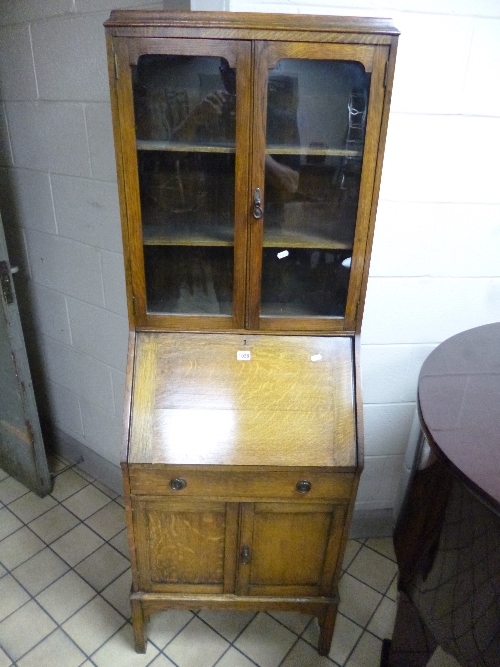 A SLIM OAK BUREAU/BOOKCASE, with a single drawer