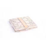 A PRESENTATION WHITE METAL COMPACT, with floral decoration either side central divider,